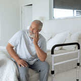 Senior Citizen next to the Vaunn Bed Rail Assist Handle with Strap