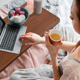 Person using laptop on top of overbed table